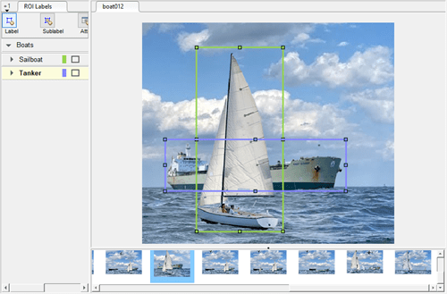 Sailboat in the foreground and tanker ship in the background