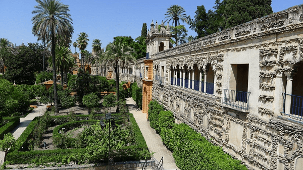 A wall and gardens of the Alcazar royal palace in Seville, Spain