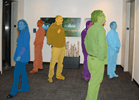 Group of people waiting by elevators, each with a different color pixel-filled mask outlining their form.